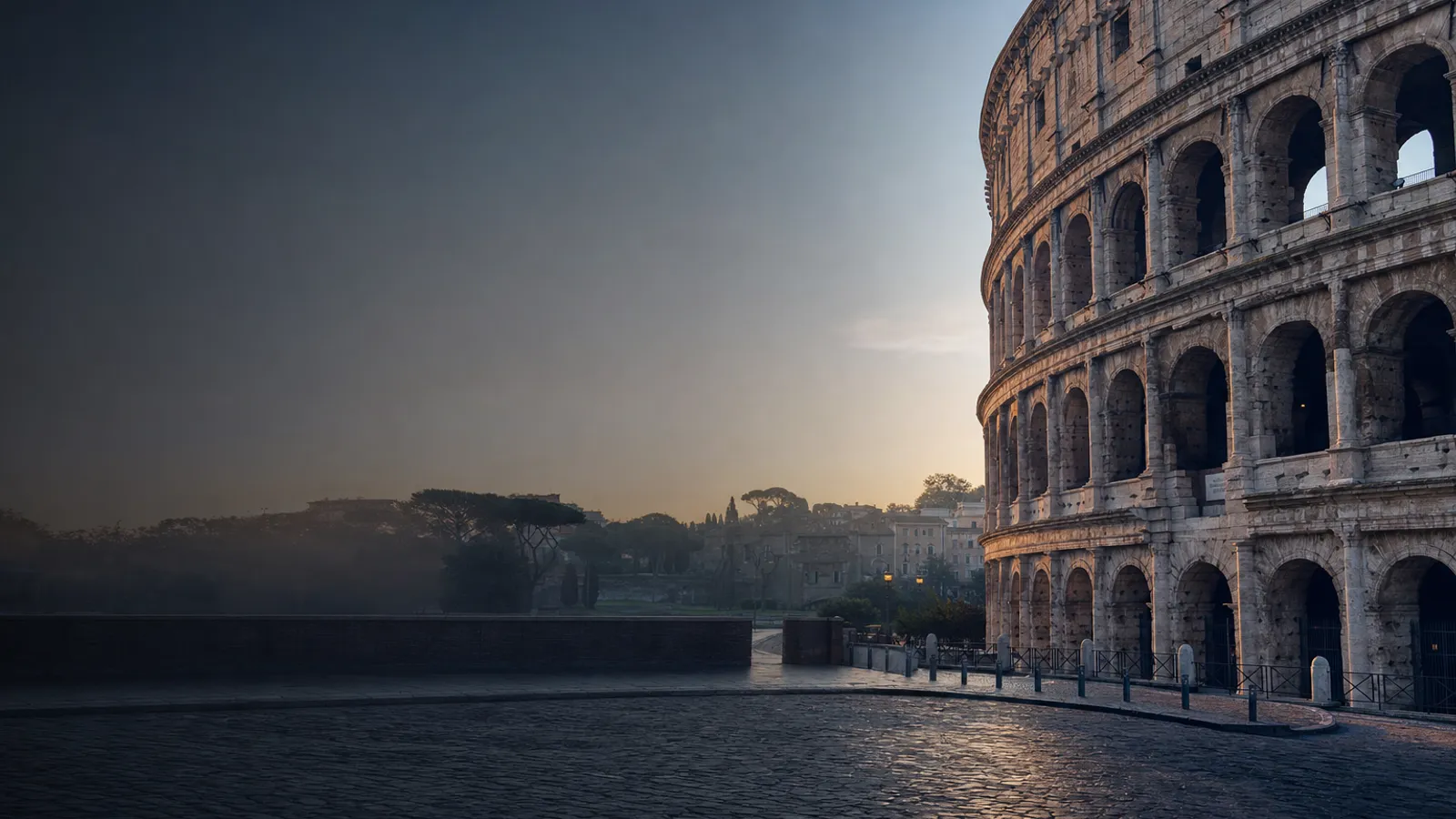 The Colosseum's arches in early morning light with empty cobblestones