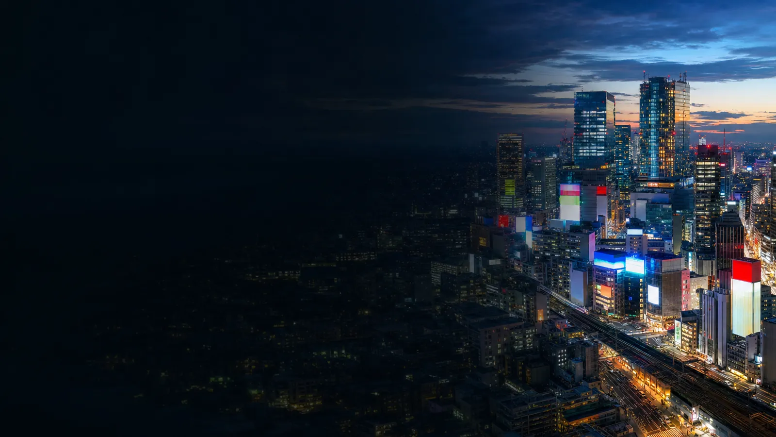 Shibuya's towers glowing over Tokyo at blue hour
