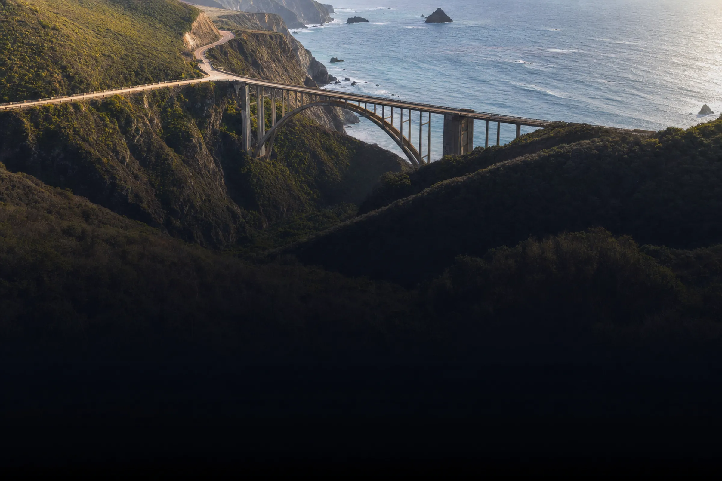 Aerial view of Bixby Creek Bridge arcing over its canyon on Highway 1, Big Sur