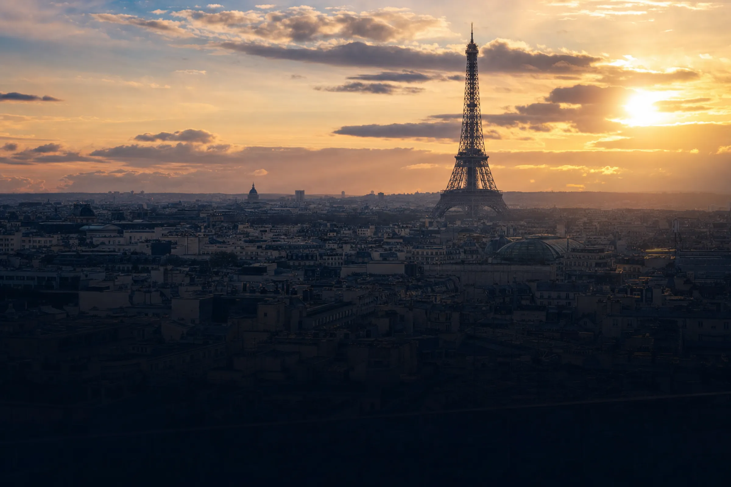 The Eiffel Tower silhouetted against a dramatic golden sunset, Paris